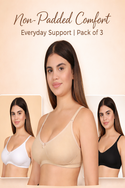 Woman wearing a beige non-padded bra with insets of other bra colors on a beige background.